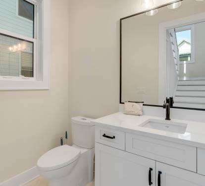 Your private bathroom features clean white vanity, stylish fixtures, and natural light from the window.