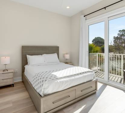 Wake up to natural light streaming through your private balcony doors in this serene bedroom retreat.