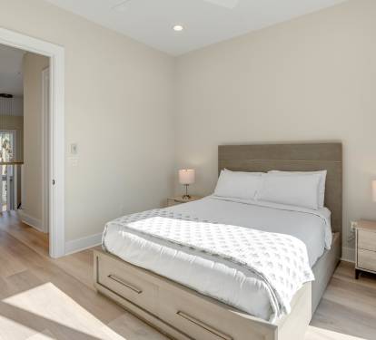 Your serene bedroom sanctuary awaits with crisp linens, warm bedside lighting, and contemporary comfort for the perfect night's rest.