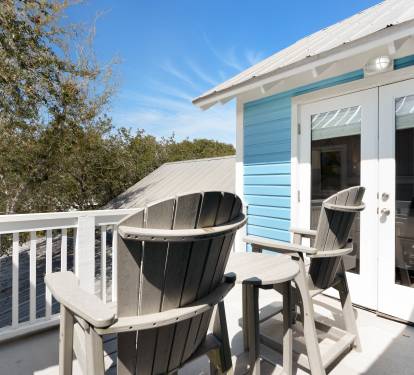 Step onto your private balcony where coastal breezes meet comfortable Adirondack chairs—perfect for morning coffee or evening relaxation.