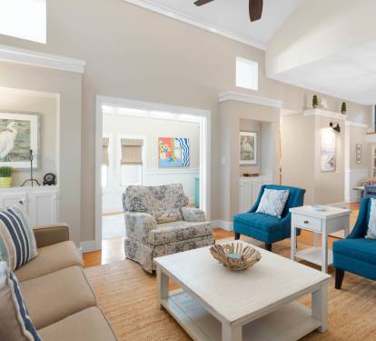Sink into coastal comfort in your stylish living area, where teal accents and nautical touches create the perfect seaside retreat.