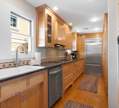 Your fully equipped kitchen features beautiful wood cabinetry, modern stainless appliances, and everything you need to create memorable meals together.
