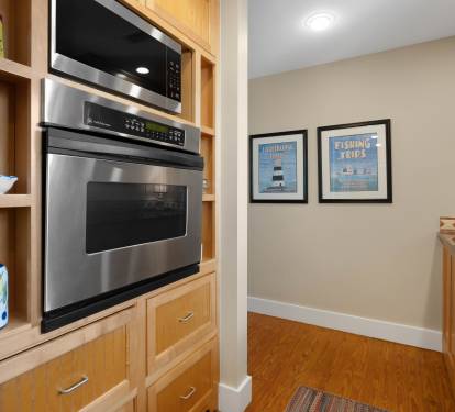 Your modern kitchen features stainless steel appliances and warm wood cabinetry, creating the perfect space for preparing meals during your stay.