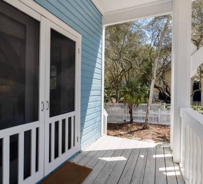 Your private entrance opens to a charming covered porch with peaceful garden views through mature trees.