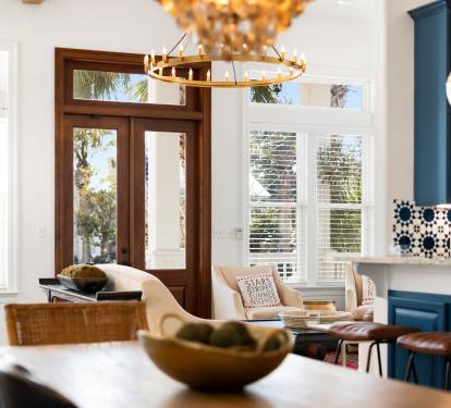 Your stylish kitchen flows seamlessly into the living area, where warm lighting and coastal views create the perfect space for cooking and relaxing together.