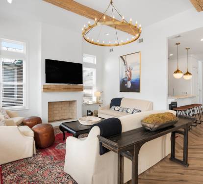 Unwind in your elegant living space with vaulted ceilings, rustic beams, and cozy fireplace creating the perfect atmosphere for relaxation.