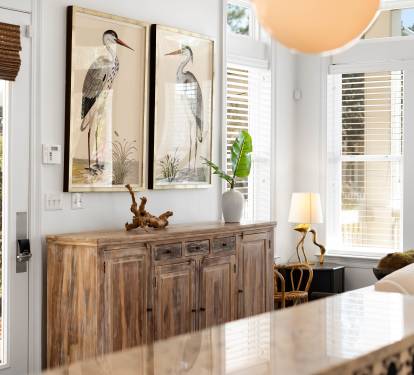 Relax at your elegant dining table while natural light streams through windows, creating the perfect spot for morning coffee or evening meals.