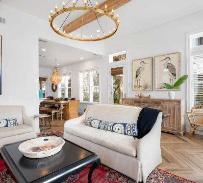 Sink into plush seating surrounded by coastal-inspired artwork and warm wood accents, where natural light streams through plantation shutters.