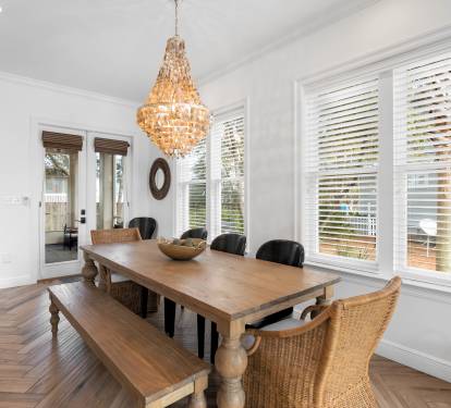 Gather around this elegant dining space where a stunning chandelier creates warm ambiance for memorable meals with loved ones.
