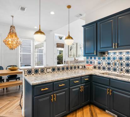 Your gourmet kitchen features navy cabinets, gold hardware, and stunning mosaic tiles—perfect for creating memorable meals together.