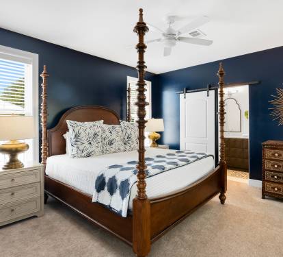 Sleep peacefully in your elegant four-poster bed surrounded by rich navy walls and thoughtful furnishings that create the perfect retreat.