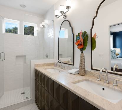Indulge in your luxurious master bathroom featuring dual vanities, elegant marble countertops, and a spacious glass-enclosed shower for ultimate relaxation.