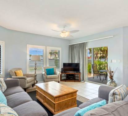 Sink into plush seating and unwind in your bright, airy living space with garden views and tropical breezes flowing through.