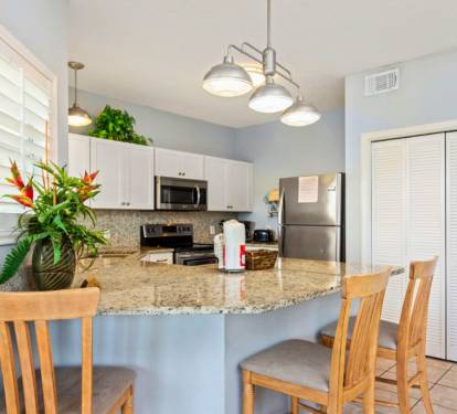 Bright Coastal Kitchen with Granite Counters & Breakfast Bar Seating