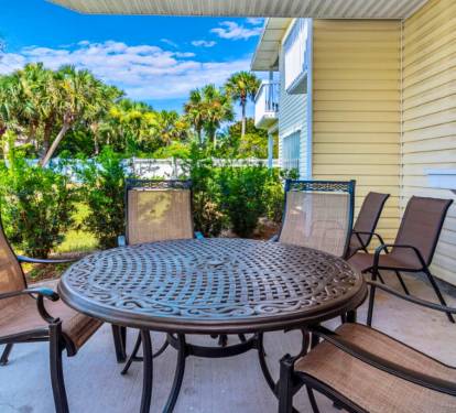 Your private outdoor dining space features a round table for six, perfect for morning coffee or sunset dinners overlooking lush tropical gardens.