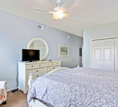 Drift into peaceful dreams in your serene bedroom with soft linens, gentle ceiling fan, and calming coastal colors creating the perfect retreat.
