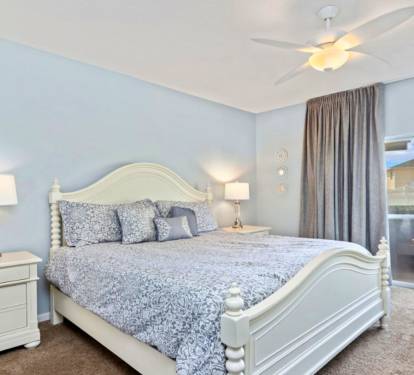 Drift off to sleep in your serene master bedroom, complete with elegant bedding and calming blue walls that create a peaceful retreat.