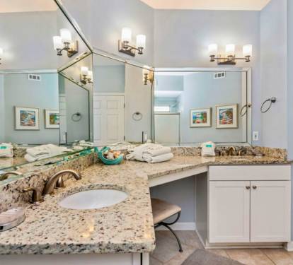 Luxurious granite vanity with dual sinks offers you ample space to prepare for your day in this elegantly appointed bathroom.