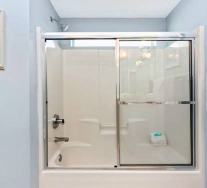 Unwind in your private bathroom with a spacious tub-shower combo and calming blue walls that create a spa-like retreat.