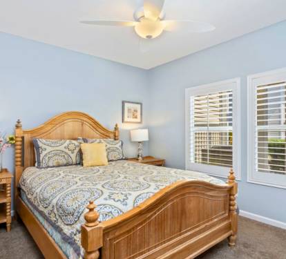 Drift into peaceful dreams in your serene blue sanctuary, where soft morning light filters through plantation shutters and fresh flowers welcome you home.