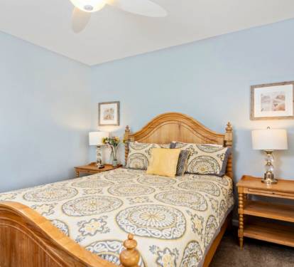 Sink into your comfortable bed surrounded by soothing blue walls and warm wooden furniture for the perfect night's rest.