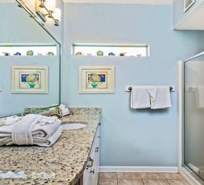 Refresh in your serene bathroom with granite counters, soft towels, and coastal-themed touches that make your morning routine feel like a spa escape.