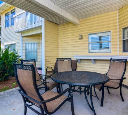 Enjoy morning coffee or evening meals on your private patio with comfortable seating for four, overlooking the peaceful garden.