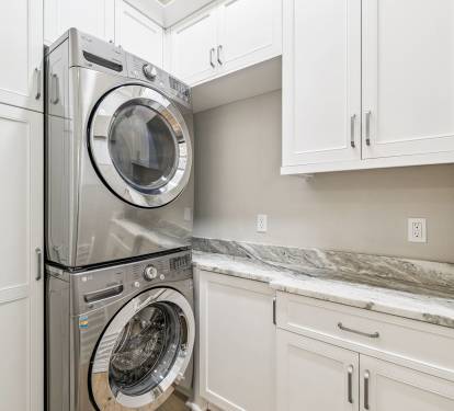 Stack Washer & Dryer Located in the Laundry Area