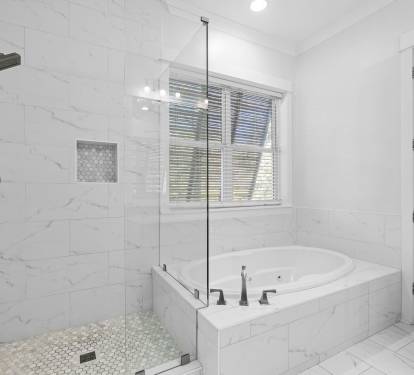 1st Floor Primary En Suite - Featuring a Glass-enclosed Shower and Separate Soaking Tub