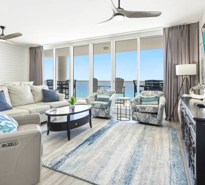 Sink into plush seating while soaking up breathtaking ocean views from your private balcony in this bright, airy living space.