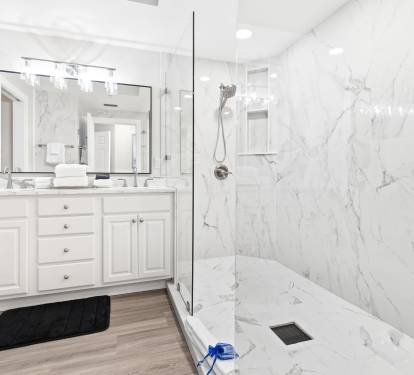Luxurious marble bathroom with spacious walk-in shower and elegant vanity awaits your morning routine.