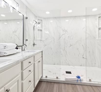 Luxurious marble bathroom featuring a spacious walk-in shower and soaking tub, where you can unwind in sophisticated comfort.