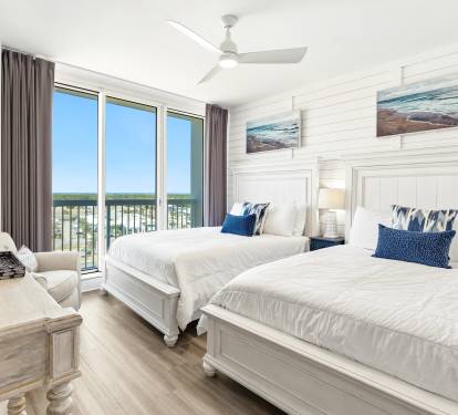 Drift off to sleep in your coastal-themed bedroom with two plush beds and stunning views through floor-to-ceiling windows.