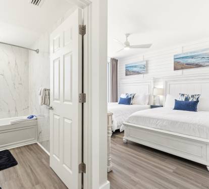 Unwind in your coastal-inspired bedroom with twin beds and crisp linens, plus an elegant marble bathroom for your comfort.