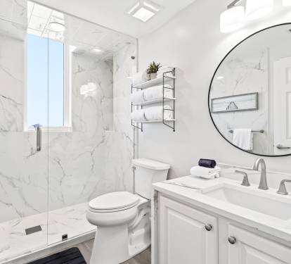 Step into your private marble sanctuary featuring a spacious walk-in shower and elegant vanity, where luxury meets comfort.
