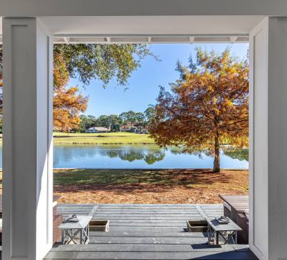 Step onto your private covered patio and soak in breathtaking lake views framed by golden autumn trees.