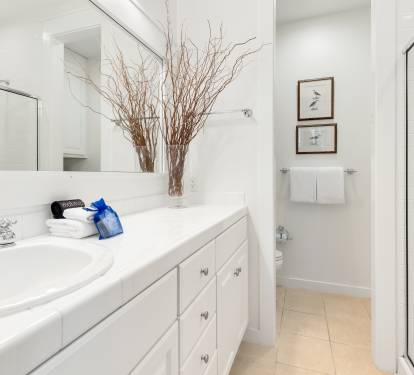 Your pristine bathroom features crisp white marble, plush towels, and elegant touches that create a spa-like sanctuary for your daily routines.