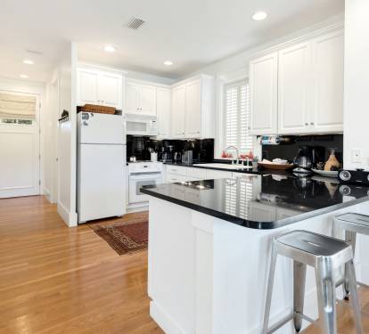 Your fully equipped kitchen features gleaming granite counters, white cabinetry, and modern stainless appliances—perfect for whipping up morning coffee or evening meals.