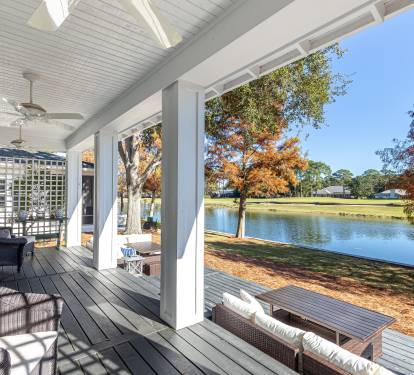 Relax on your private covered porch with stunning lake views, comfortable seating, and peaceful autumn surroundings.