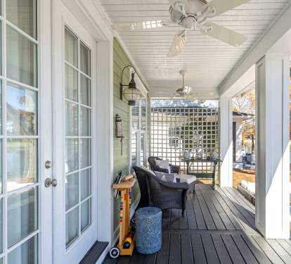 Unwind on your private covered porch with comfortable seating and gentle ceiling fans, overlooking peaceful water views.