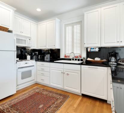Your fully equipped kitchen features crisp white cabinets, granite countertops, and everything you need to prepare meals during your stay.