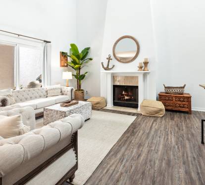Sink into plush sectional seating by your cozy fireplace, where natural light streams through and coastal vibes create perfect relaxation.