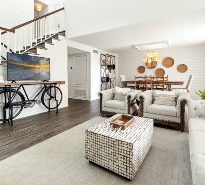 Unwind in your stylish living space where modern comfort meets coastal charm, complete with plush seating and thoughtful design touches.