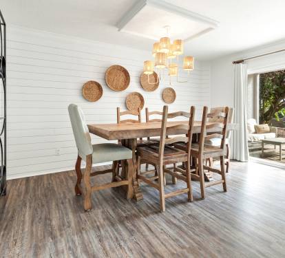 Gather around this gorgeous rustic dining table where warm woven accents and coastal charm create the perfect atmosphere for memorable meals with loved ones.
