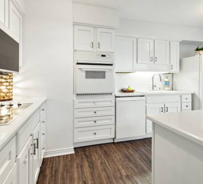 Your bright, fully-equipped kitchen invites culinary adventures with gleaming countertops, modern appliances, and ample storage for all your cooking needs.