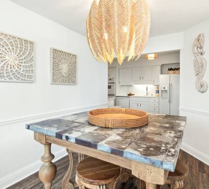 Gather around this stunning marble dining table beneath a statement chandelier, with the fully equipped kitchen just steps away for your culinary adventures.