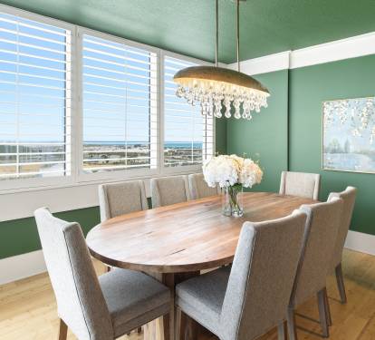 Gather around this elegant dining table for memorable meals while enjoying stunning ocean vistas through floor-to-ceiling windows.