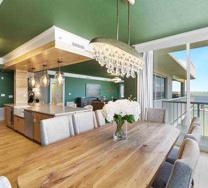 Gather around this beautiful dining space where your meals become special occasions, framed by stunning lake views.