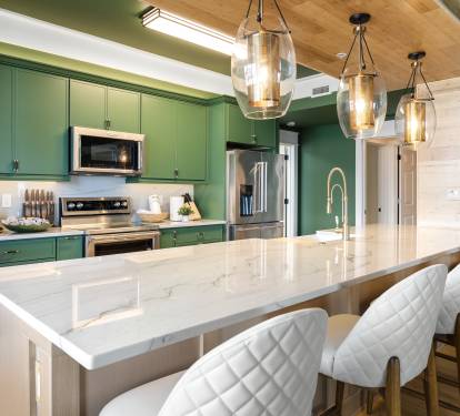 Your gourmet kitchen awaits with emerald cabinets, marble countertops, and stylish pendant lighting for memorable cooking experiences.
