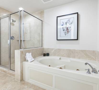 Indulge in your private spa retreat with a luxurious jetted tub and separate glass shower, perfect for unwinding after exploring.